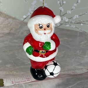 Vintage 1980’s hand painted Santa kicking a soccer ball.